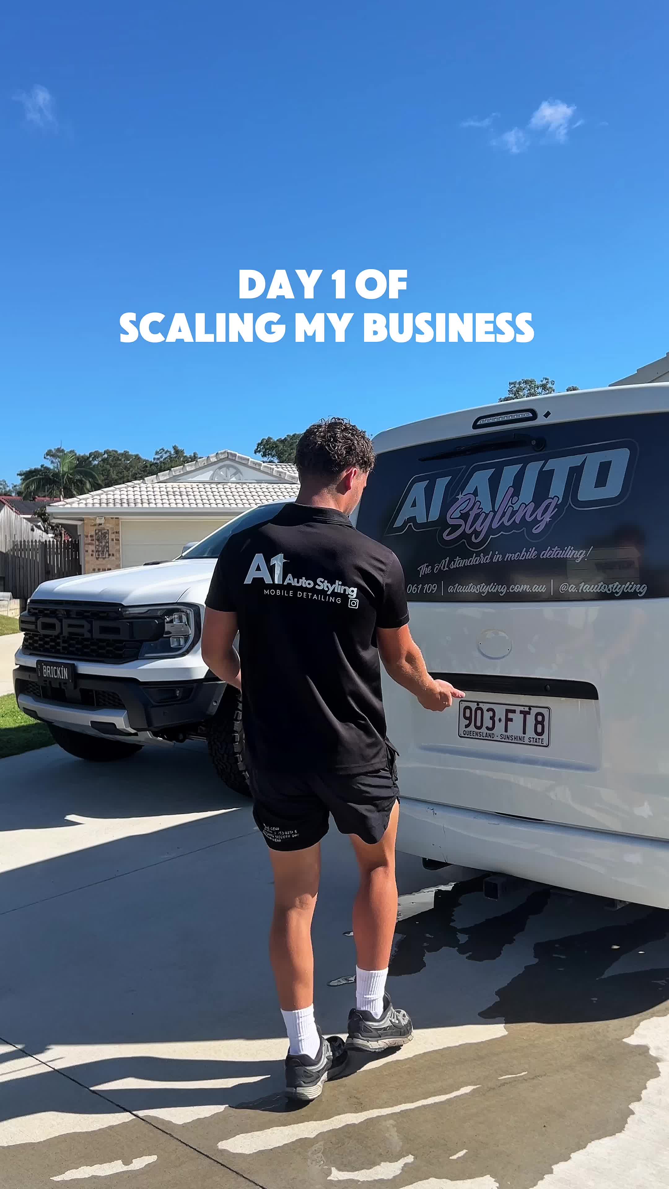 Beau McClymont in A1 Auto Styling uniform walking between his branded van and a customer Ford Raptor