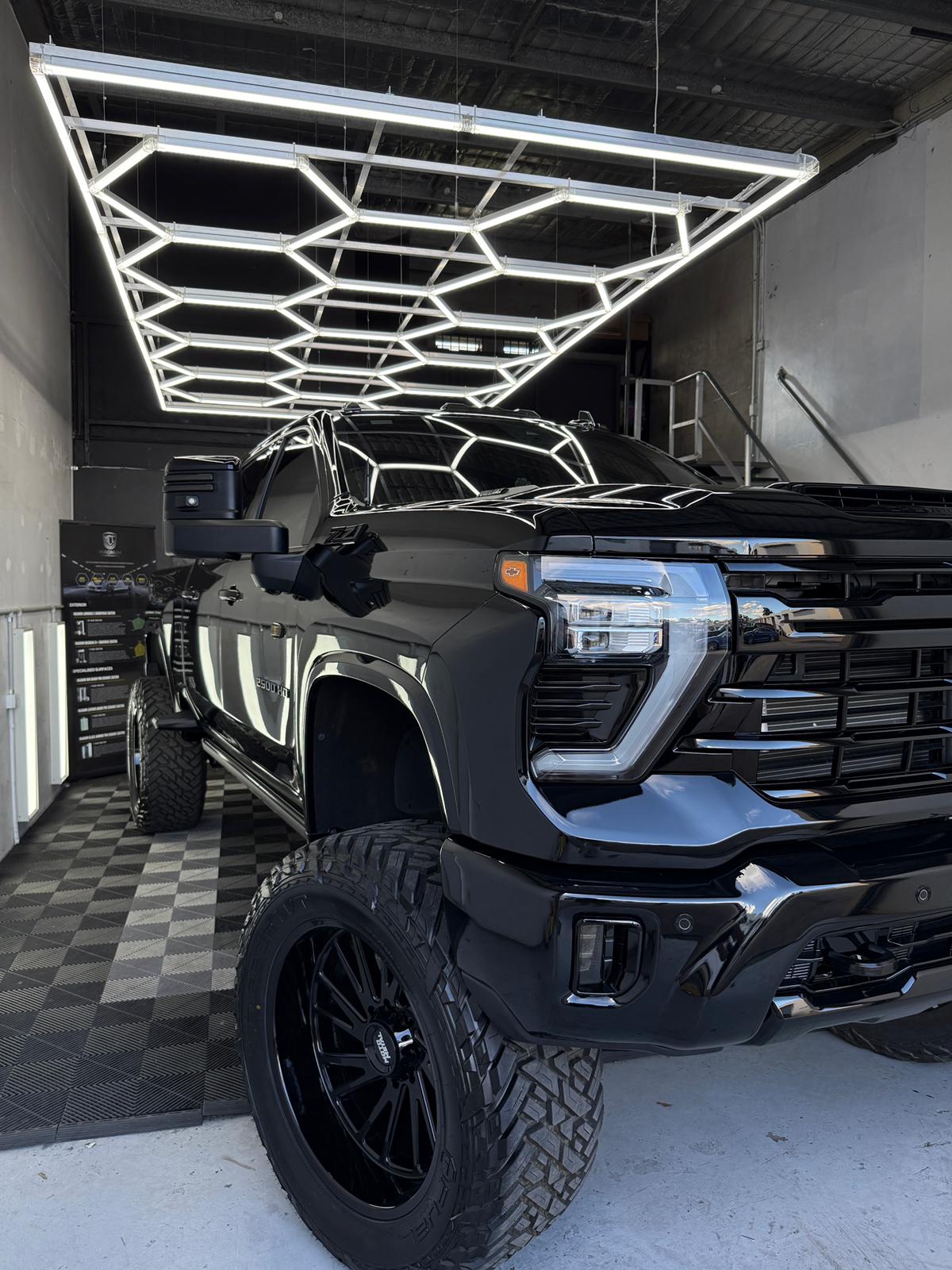 Black lifted Chevy Silverado HD2500 in the A1 Auto Styling workshop